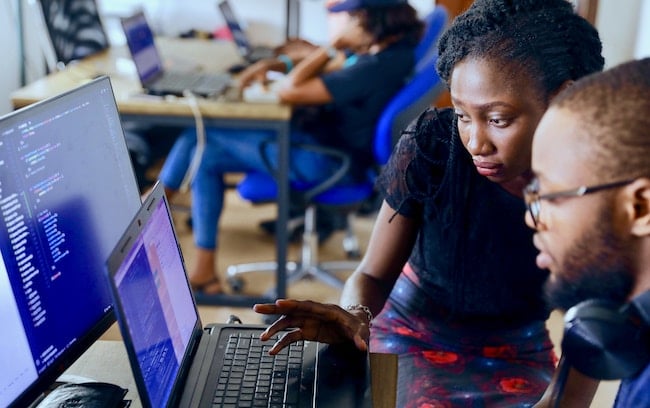 Two people looking at a computer